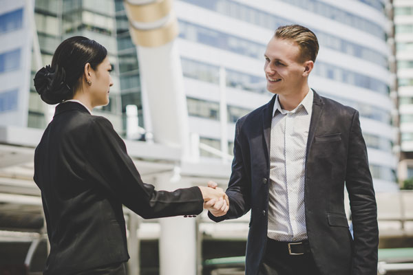 business-people-shaking-hands-outside-an-office