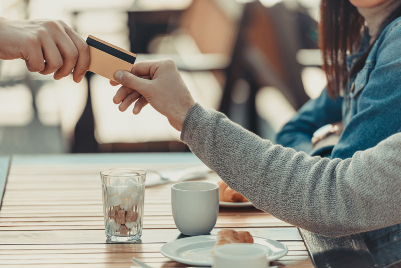 cropped-shot-of-couple-paying-with-credit-card