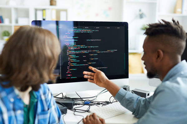 software-developers-discussing-code-at-workplace